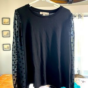Black women’s top with sheer polkadot sleeves